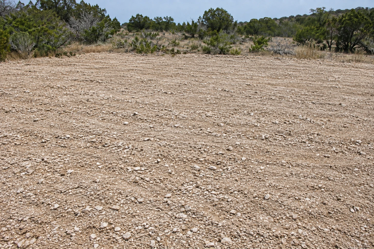 Clean, evenly milled limestone surface across the same ranch work area